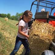 Girl Loading Straw Bale